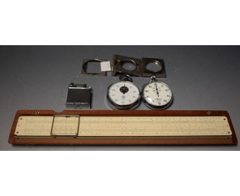 An Heuer chrome pocket stopwatch; another similar stopwatch; a cased slide rule; a chrome cigarette lighter; a loop (5)