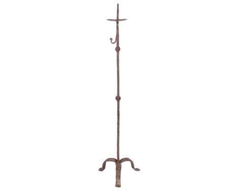 Wrought iron candlestick. Gothic. 15th century.Height: 97 cm.Supported on a tripod, the shaft features delicate forged decora