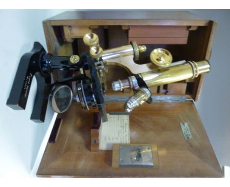 An early 20thC E Leitz Wetzlar black enamelled steel and lacquered brass microscope No.148216, having three rotating lenses  