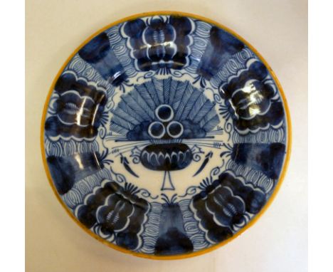 A late 18thC Dutch Delft tin glazed earthenware plate, decorated in blue and white with feathered and other designs  inscribe