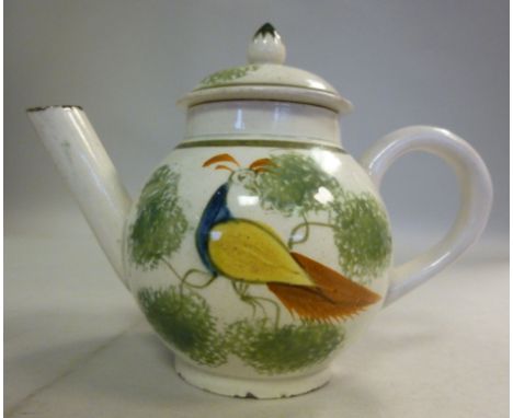 A late 18thC Pearlware miniature teapot of globular form, having a straight, angled spout, loop handle and an onion knop on t