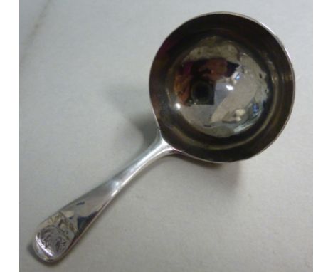 A George III silver Old English pattern caddy spoon, having a bowl, the terminal with an engraved armorial  RC  London 1792