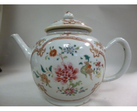 An early 19thC Chinese porcelain teapot of bulbous form, having a straight, angled spout, loop handle and lid with a bud fini