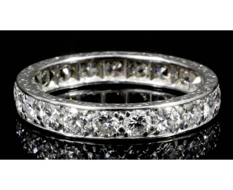 A modern silvery coloured metal mounted all diamond set full  hoop eternity ring, the face set with twenty-one brilliant cut 