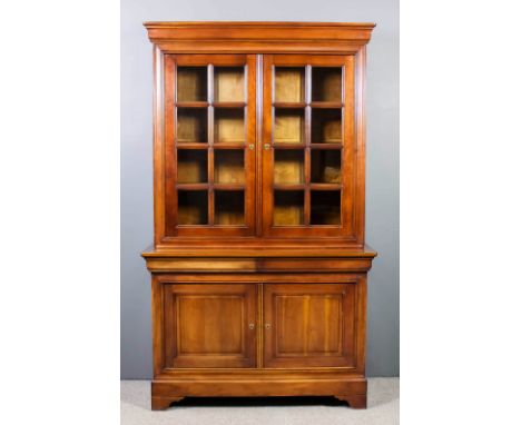 A modern French panelled cherry wood chiffonier bookcase, the upper part with moulded cornice, fitted three shelves, enclosed