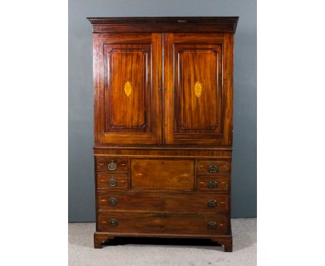 A gentleman's mahogany wardrobe in the "Georgian" manner, the front inlaid with stringings, the upper part with dentil moulde
