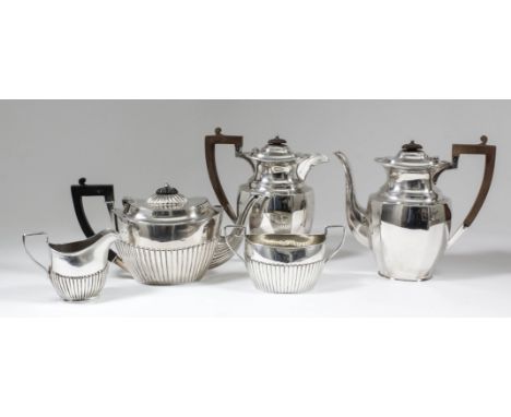 A Victorian and George V harlequin silver oval three piece tea service with part reeded bodies and angular handles, comprisin