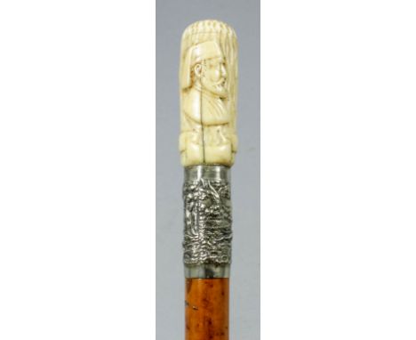 A late 19th/early 20th Century carved ivorine and plated metal mounted walking cane, the bark pattern handle carved in relief