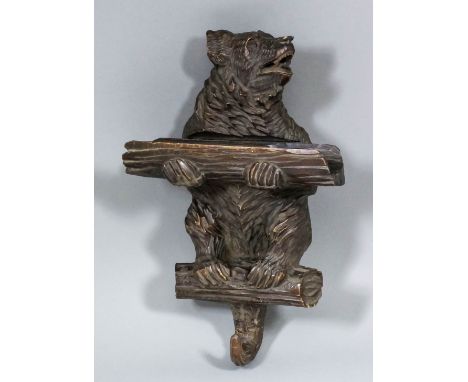 A late 19th / early 20th Century Black Forest lindenwood bear pattern wall mounted stick stand and coathook, carved in the fo