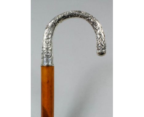 A late 19th/early 20th Century Chinese silver mounted walking stick, the handle cast with dragons, 34.75ins overall (indeciph