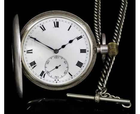 An early 20th Century gentlemen's silver half hunting cased keyless lever pocket watch, the white enamelled dial with Roman n