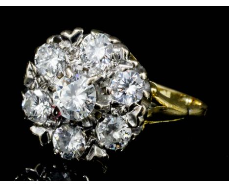 A modern 18ct white and yellow gold mounted all diamond set flowerhead pattern ring, the face set with seven brilliant cut di