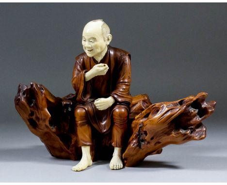 A Private Collection of Oriental Ivories  A Japanese carved boxwood and ivory figure of a man seated on a tree trunk, 8.625in