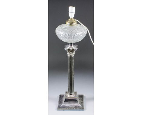 A plated table oil lamp of Corinthian column form, on stepped square base with bead mounts and with cut glass reservoir, 24in