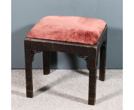 A 1920s stained mahogany rectangular stool of 18th Century design, the drop-in seat upholstered in dark pink cloth, on square