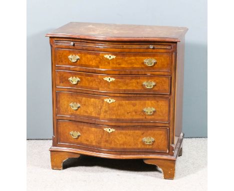 A 20th Century figured walnut serpentine fronted chest, the whole crossbanded with moulded edge and quarter veneered top, fit