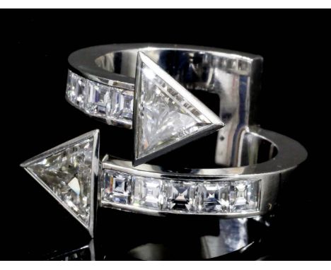 A modern platinum mounted all diamond set arrowhead pattern ring, the face set with two 1930's triangular cut diamonds, each 
