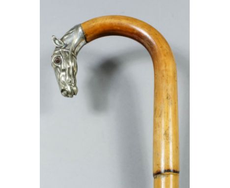 A late 19th/early 20th Century plated metal "horse" pattern walking stick, the curved handle cast as a horse head inset with 