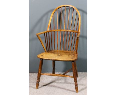 A 19th Century ash and elm seated stick back Windsor arm chair with two tier stick back, on turned legs and stretchers