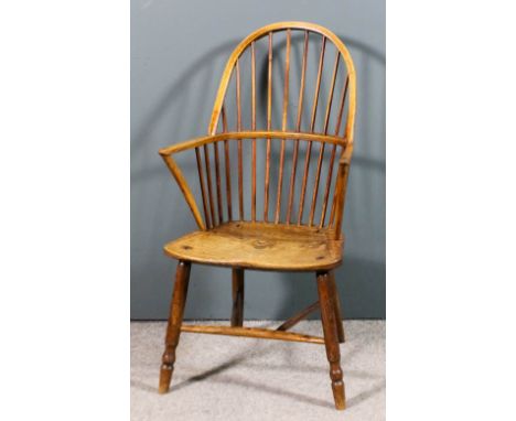 A 19th Century ash and elm seated stick back Windsor arm chair with two tier stick back, on turned legs and stretchers