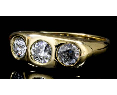 A George V gentleman's 18ct gold and diamond set three stone gypsy ring, the central old cut diamond of approximately .40ct, 