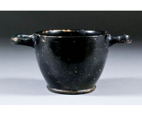 A terracotta black glazed Greek wine cup (skyphos), 3.75ins diameter (excluding handles) x 2.75ins high (circa 350 BC)