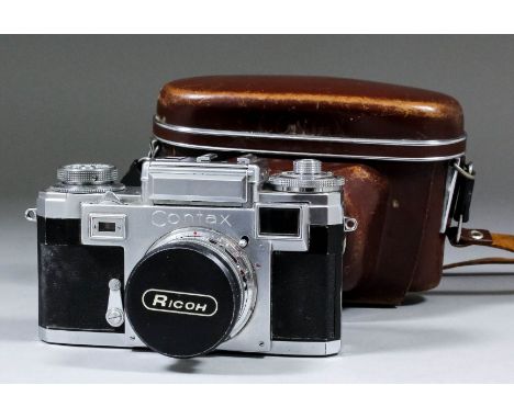 A mid-1950s Contax IIIA range finder camera with Zeiss lens and brown leather case for same