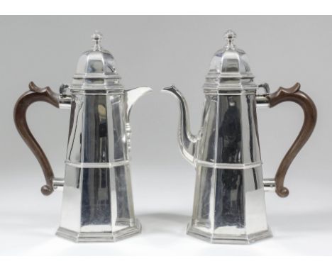 A George V silver octagonal coffee pot and matching hot water jug of "18th Century" design, of tapered form with domed covers