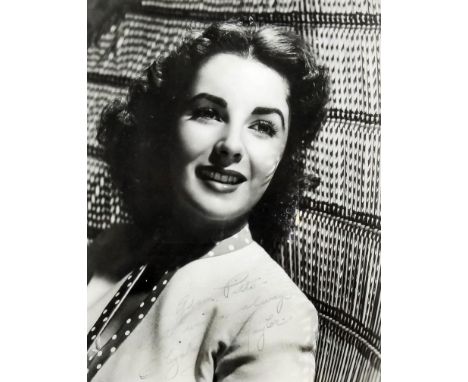 A 1950's autographed black and white photograph of Elizabeth Taylor, 10ins x 8ins, framed and glazed Provenance: Given to the