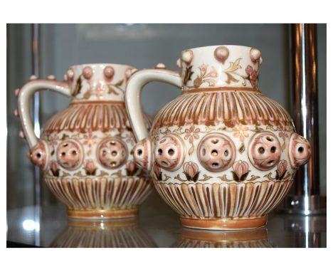 Pair of Hungarian Zsolnay Pecs pottery ewers of spherical form with studded rims, handles and pierced medial band, impressed 