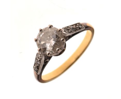 Yellow metal and solitaire diamond ring, stone measures approximately 6.5mm diameter x 4mm deep, between diamond-set platinum