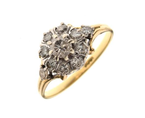 Yellow metal and diamond cluster ring, the central stone within a border of eight smaller stones and two further to the split