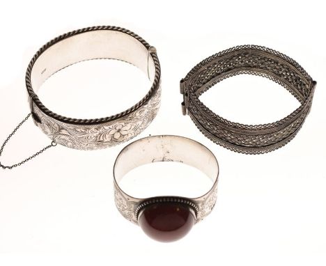 Two white metal snap bangles and a napkin ring with large hardstone cabochon (3)  