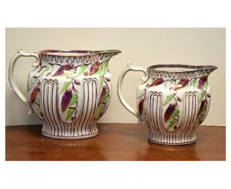 Two early 19th Century pearl-glazed pottery puce lustre relief-moulded jugs, the larger 15cm high (2)  