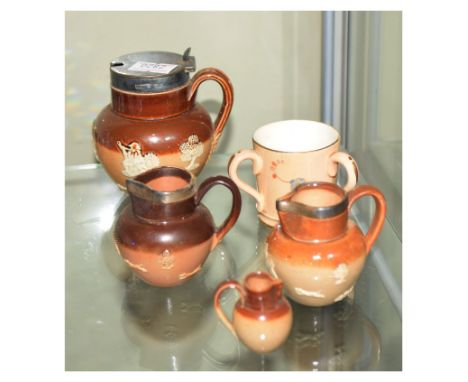 Three Doulton stoneware miniature jugs, three of which have hallmarked silver collars, together with a Royal Worcester tyg  