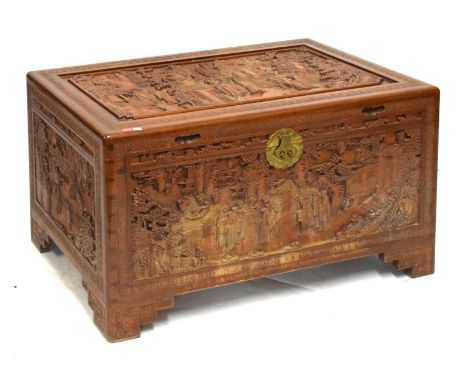Mid 20th Century Oriental carved camphor wood chest or trunk with hinged rectangular top and front, both decorated with figur