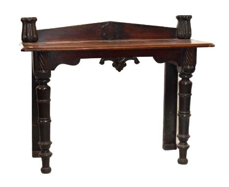 19th Century mahogany console table, the canted bevelled oblong top with shaped shield-centred low pediment and carved foliat
