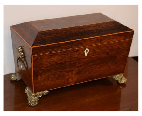 Regency rosewood sarcophagus-form tea caddy, the hinged cover enclosing two lidded compartments flanking a blending bowl aper
