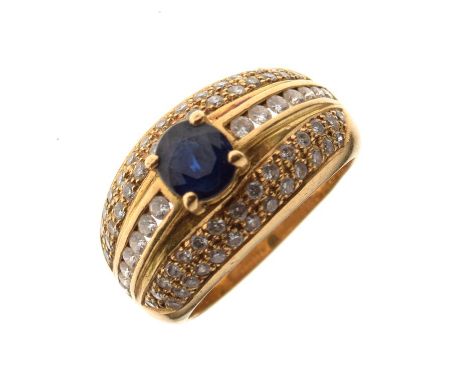 Yellow metal, sapphire and diamond dress ring, the large central faceted oval sapphire between seventy small diamond brillian