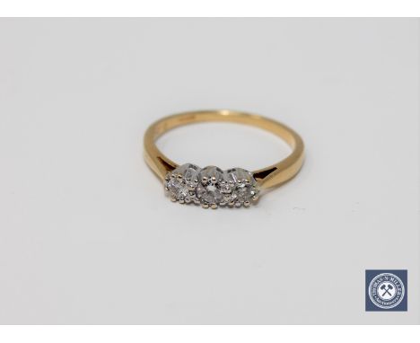 An 18ct gold three stone diamond ring, approximately 0.2ct.