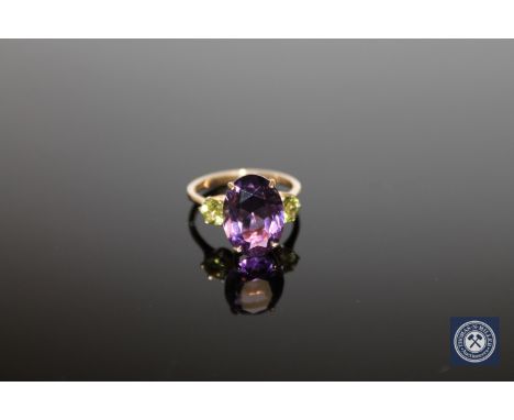 A 9ct gold amethyst and peridot ring, size O