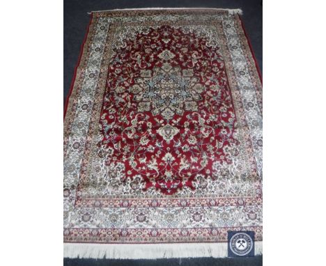 A Keshan carpet on red ground, 2.30 m x 1.60 m 