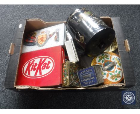 A box containing a collection of vintage tins 