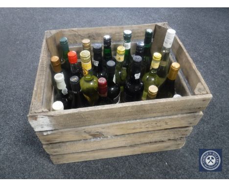 A box containing twenty-four bottles of assorted alcohol and wines and a vintage wooden crate