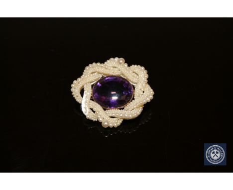 A Victorian amethyst and pearl brooch in gold mount