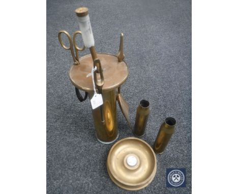 A WWII trench art companion set, two ammunition shell cases and a trench art ashtray with emblem 