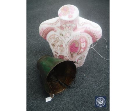 A galvanized bucket in the form of a light fitting and an illuminated mannequin torso 