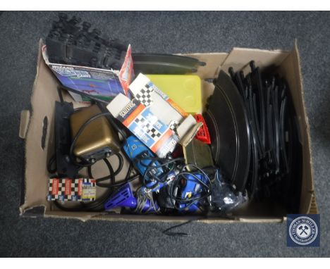 A box containing vintage Scalextric cars, track and accessories
