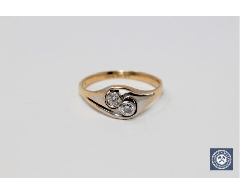 An 18ct gold two-stone diamond ring, size P