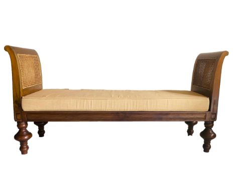 DAYBED, 20th century teak, with scroll arms, cane paneling, fitted cushion and turned supports, 170cm W. 